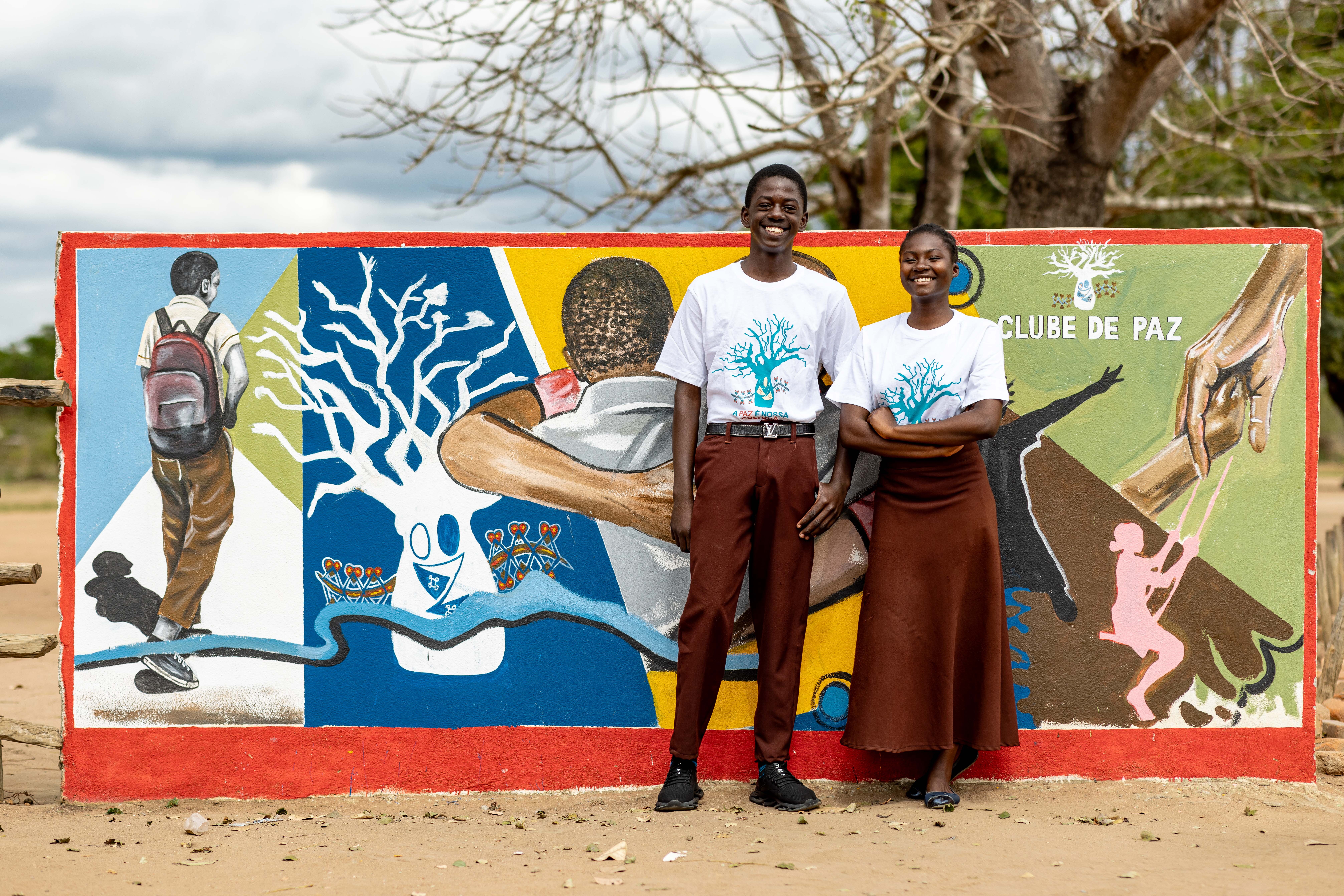 Local artists and community members take part in a collective painting of a peace-inspired mural in Muxúnguè, Sofala Province.