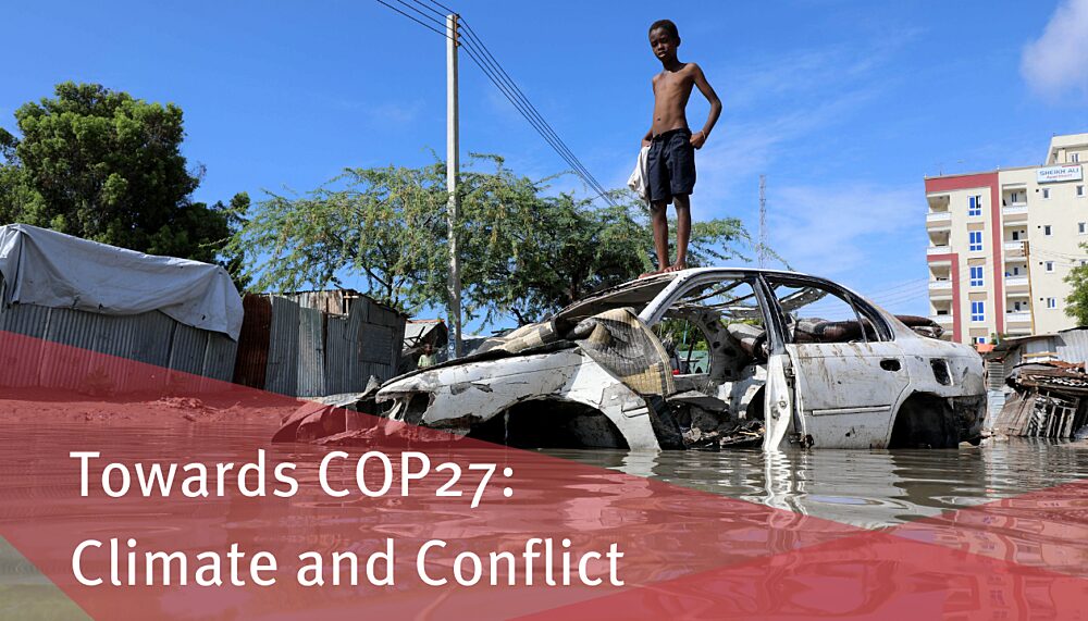 A Somali boy stands on a junk vehicle after heavy rain in Mogadishu