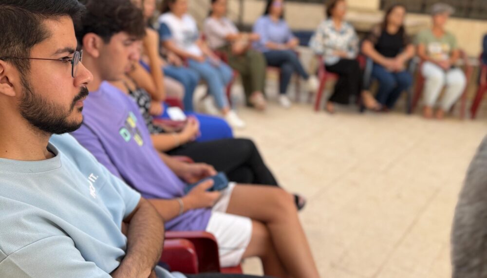 Community members of different age groups engaging in a dialogue session in Kfeir, Lebanon.