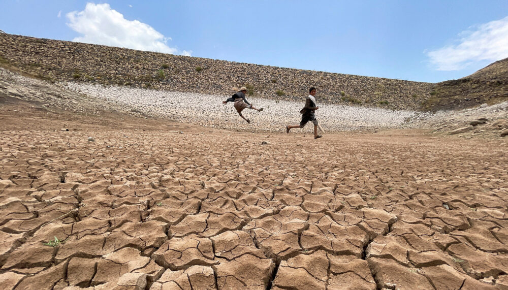 Boys play in a dried up dam in Khawlan, Yemen, one of the world's most water-stressed countries, where climate change-induced drought and the lack of sustainable water supplies prevail.
