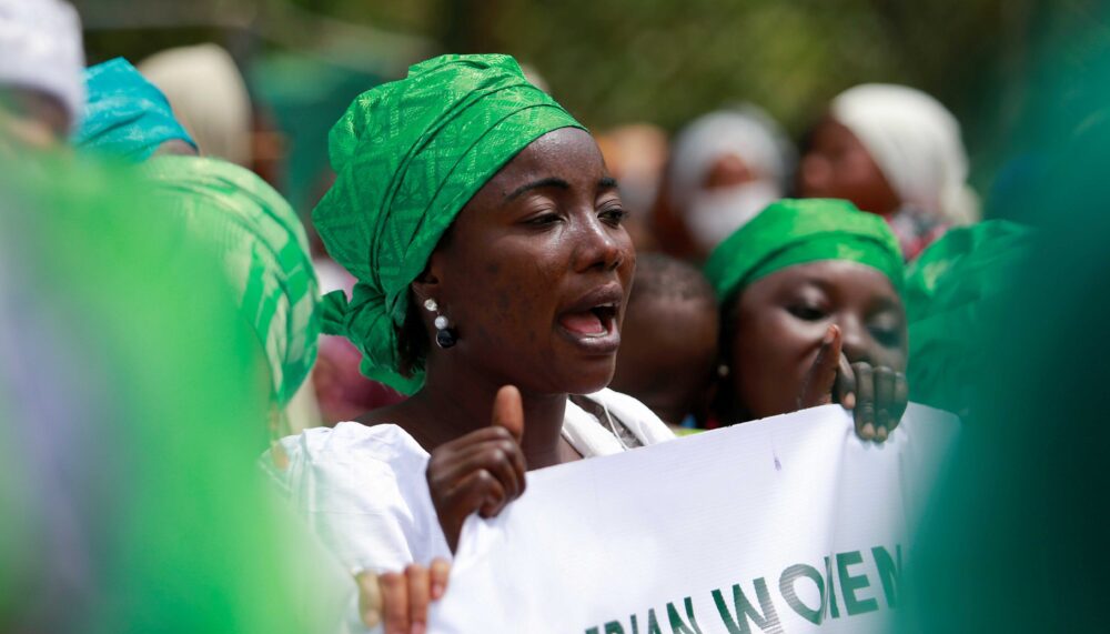 A woman holds a banner during a protest against legislative bias against women, on the International Women's Day, in Abuja, Nigeria March 8, 2022. The protest has been followed by a lockdown of the National Assembly Complex.