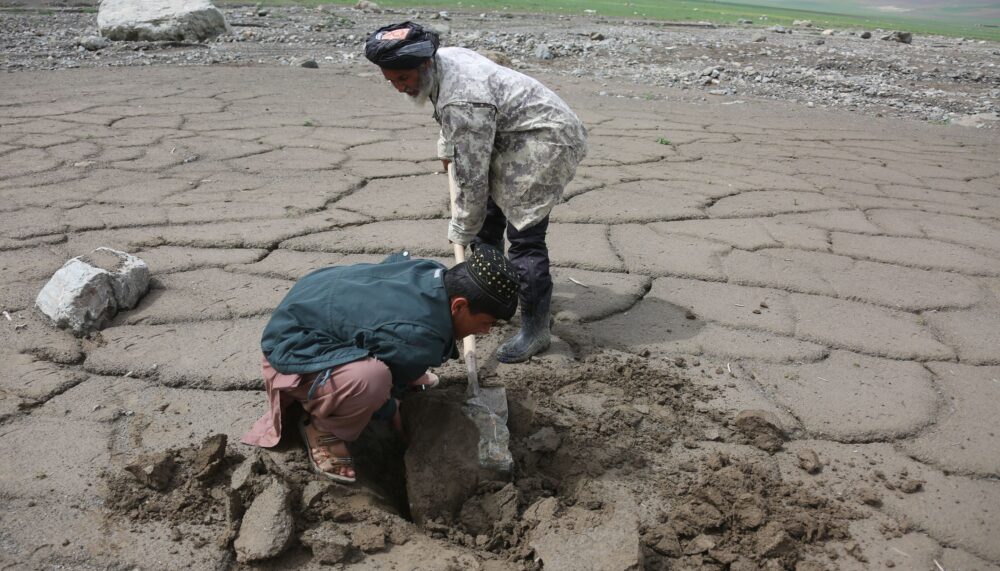 BAGHLAN, April 22, 2025 (Xinhua) -- Farmers work on agricultural land affected by recent floods in Burka district in northern Baghlan province, Afghanistan, April 20, 2025. TO GO WITH "Feature: Afghans at the crossroads of climate crisis, deepening poverty" (Photo by Saifurahman Safi/Xinhua)