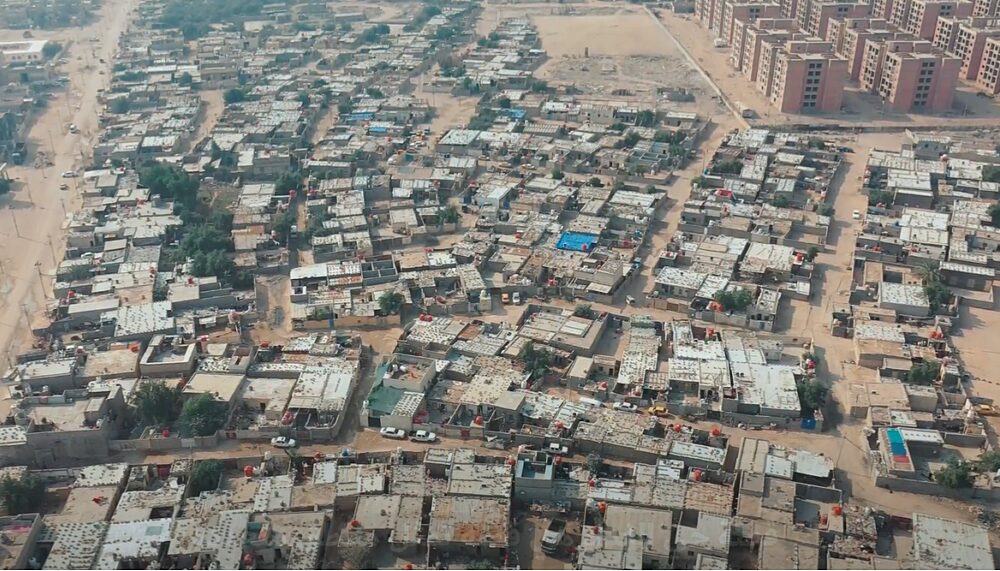 Arial view of the city of Basra in Iraq. You can see dusty roads and many residential buildings from above.