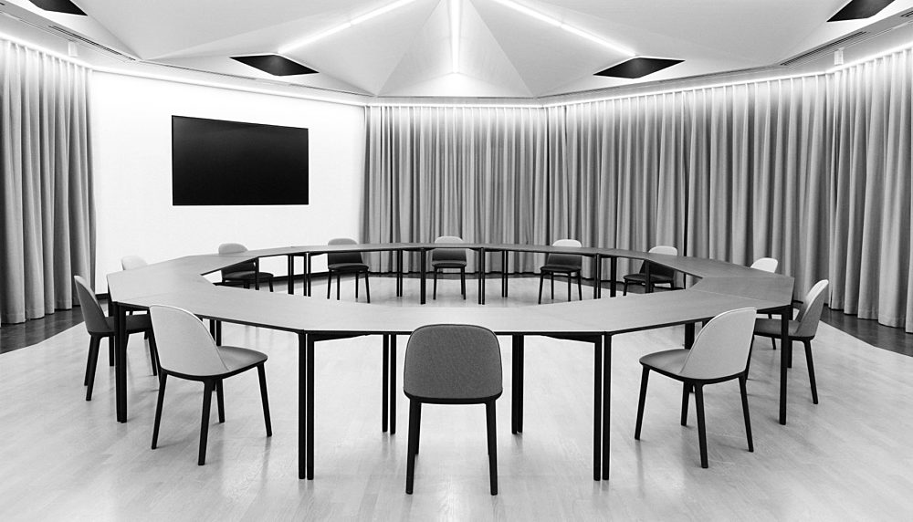 Conference room with chairs and tables in a circle
