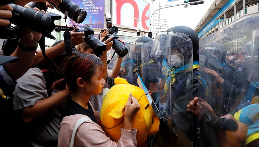 A female protester in front of a police line during a demonstration near the Asia-Pacific Economic Cooperation (APEC) forum venue in Bangkok in 2022.