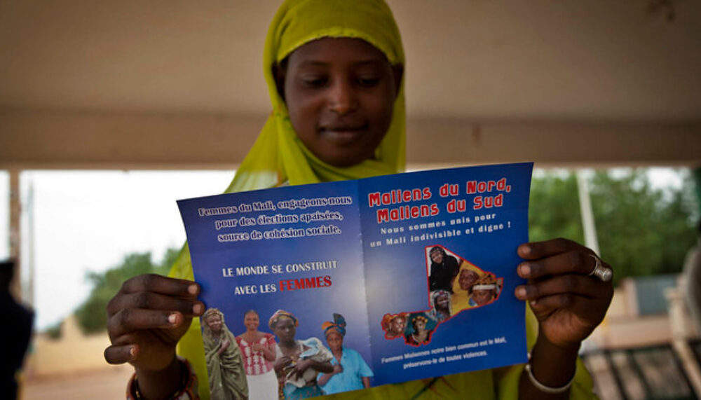 A young woman reads the official informational flyer of the Peace Caravan in Gao, Mali. August, 2013.